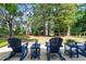 Cozy backyard seating area with chairs, side tables, and lush greenery surrounding the outdoor space at 1514 Village Sq, Mount Pleasant, SC 29464
