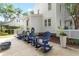 Relaxing outdoor patio area with comfortable blue Adirondack chairs and a tranquil backyard setting at 1514 Village Sq, Mount Pleasant, SC 29464