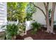 Charming backyard featuring a white picket fence and manicured garden beds with colorful plants at 1514 Village Sq, Mount Pleasant, SC 29464