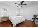 Relaxing bedroom with white bedding, hardwood floors, and a ceiling fan at 1514 Village Sq, Mount Pleasant, SC 29464