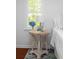 Bedroom detail of side table with a lamp and blue hydrangeas at 1514 Village Sq, Mount Pleasant, SC 29464
