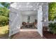 Dining area with table, chairs, and view through open doors to exterior brick pathway at 1514 Village Sq, Mount Pleasant, SC 29464