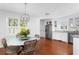 Bright dining area with hardwood floors, stylish light fixture, and views to the kitchen at 1514 Village Sq, Mount Pleasant, SC 29464