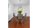Bright dining room featuring a round table, four chairs, a modern light fixture, and beautiful hardwood floors at 1514 Village Sq, Mount Pleasant, SC 29464