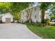 Charming white home with a detached garage, long driveway, and manicured landscaping at 1514 Village Sq, Mount Pleasant, SC 29464