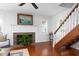 Well-lit living room featuring a fireplace and wood stairs with natural lighting at 1514 Village Sq, Mount Pleasant, SC 29464