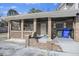 Charming brick front porch with sturdy brick columns, a security screen door, and a seating area at 1520 Acacia St, Charleston, SC 29407