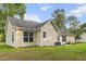 Home's rear exterior featuring a pristine lawn and manicured plants, creating a serene backyard oasis at 1583 Southwick Dr, Johns Island, SC 29455