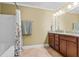 Bathroom features a shower/tub combo, double sink vanity, and granite countertops at 1583 Southwick Dr, Johns Island, SC 29455