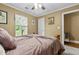 Cozy bedroom features a ceiling fan, neutral tones and a window with natural light at 1583 Southwick Dr, Johns Island, SC 29455