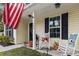 Cozy front porch with rocking chairs, flowers, and charming decorations at 1583 Southwick Dr, Johns Island, SC 29455