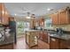 Traditional kitchen with dark countertops, wooden cabinetry, and a center island at 1583 Southwick Dr, Johns Island, SC 29455