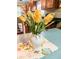 Kitchen view showcasing rich wood cabinetry complemented by fresh yellow flowers in a white vase at 1583 Southwick Dr, Johns Island, SC 29455