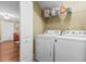 Laundry room equipped with white washer, dryer, shelving, and a utility closet at 1583 Southwick Dr, Johns Island, SC 29455