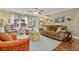Spacious living room with natural light, hardwood floors, and cozy seating furniture at 1583 Southwick Dr, Johns Island, SC 29455