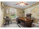 Bright home office featuring a large wooden desk, ceiling fan, and ample lighting at 1583 Southwick Dr, Johns Island, SC 29455