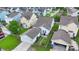 Aerial view of fenced backyards, including a patio, lawn, detached garage, and the side of a light blue house at 1870 Gammon St, Charleston, SC 29414