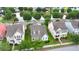 Aerial view showcases a neighborhood with a pond, mature trees, and well-maintained lawns at 1870 Gammon St, Charleston, SC 29414