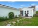 The backyard features stone pavers leading to a screened patio and a grill with tidy landscaping alongside the house at 1870 Gammon St, Charleston, SC 29414