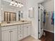 Bright bathroom with dual vanities and granite countertop provides access to a walk-in closet at 1870 Gammon St, Charleston, SC 29414