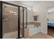 Bright bathroom offers a shower with black trim as well as separate tub at 1870 Gammon St, Charleston, SC 29414