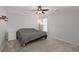 Cozy bedroom with neutral carpet, fan, and a sun-filled window at 1870 Gammon St, Charleston, SC 29414