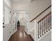 Entryway view of stairs with carpet runner, decorative railings and hardwood floors leading to a flex room at 1870 Gammon St, Charleston, SC 29414