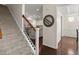 Entryway view of stairs with carpet runner, decorative railings and hardwood floors leading to the open kitchen at 1870 Gammon St, Charleston, SC 29414