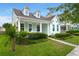 Beautiful home featuring a cozy front porch, dormer windows, manicured shrubs, and a well-kept lawn at 1870 Gammon St, Charleston, SC 29414