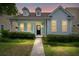 Charming one-story home featuring a covered front porch, dormer windows, and mature landscaping at 1870 Gammon St, Charleston, SC 29414