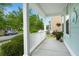 View from the covered front porch with white railings, plants, and a view of the front street at 1870 Gammon St, Charleston, SC 29414