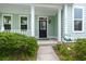 Inviting front porch with white columns, manicured bushes, and decorative welcome statues, and the home's address at 1870 Gammon St, Charleston, SC 29414