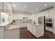 Bright kitchen with white cabinets, granite countertops, stainless steel appliances, and hardwood floors at 1870 Gammon St, Charleston, SC 29414