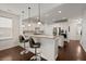 Bright, open kitchen features stainless steel appliances, granite countertops, and a breakfast bar with pendant lighting at 1870 Gammon St, Charleston, SC 29414