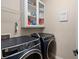 Well-equipped laundry room with modern washer and dryer, storage cabinets, and functional design at 1870 Gammon St, Charleston, SC 29414