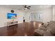 Open living room with hardwood floors, ceiling fan, and a view to the adjacent dining and kitchen areas at 1870 Gammon St, Charleston, SC 29414