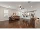Inviting living room boasts hardwood floors, fan, and seamlessly integrates with a modern kitchen at 1870 Gammon St, Charleston, SC 29414
