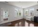 Bright sunroom with hardwood floors, lots of natural light, and access to the outdoors through a glass door at 1870 Gammon St, Charleston, SC 29414