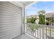 A view from the home's balcony overlooking manicured lawns and neighboring houses on a sunny day at 1876 Towne St, Johns Island, SC 29455