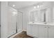 Modern bathroom with double sink vanity, framed mirrors, and glass enclosed shower at 1876 Towne St, Johns Island, SC 29455