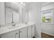 Bathroom featuring a double vanity, white cabinets, and a view of the outdoors at 1876 Towne St, Johns Island, SC 29455