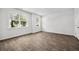 Sunlit bedroom with hard surface floors, white walls, and two windows at 1876 Towne St, Johns Island, SC 29455
