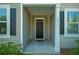 View of the townhome entrance with a black door and light gray siding at 1876 Towne St, Johns Island, SC 29455