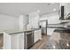 Well-equipped kitchen with stainless steel appliances, granite counters, and white cabinetry at 1876 Towne St, Johns Island, SC 29455