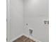 A clean laundry room with white trim, wood-look vinyl flooring, and utility connections at 1876 Towne St, Johns Island, SC 29455