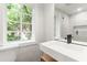 Bathroom featuring a toilet, a modern sink, a big mirror and a window with green trees view at 19 Smith St # D, Charleston, SC 29401