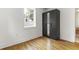 Bedroom featuring a closet with mirrors, hardwood floor and a window with trees view at 19 Smith St # D, Charleston, SC 29401