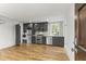 Modern kitchen featuring stainless steel appliances, sleek gray cabinets, and beautiful hardwood floors at 19 Smith St # D, Charleston, SC 29401
