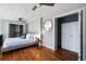 Bright bedroom with hardwood floors, a closet, and a gold mirror at 2 Francis St # I, Charleston, SC 29403