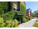 Unique brick building exterior covered in lush green ivy on a sunny day at 2 Francis St # I, Charleston, SC 29403